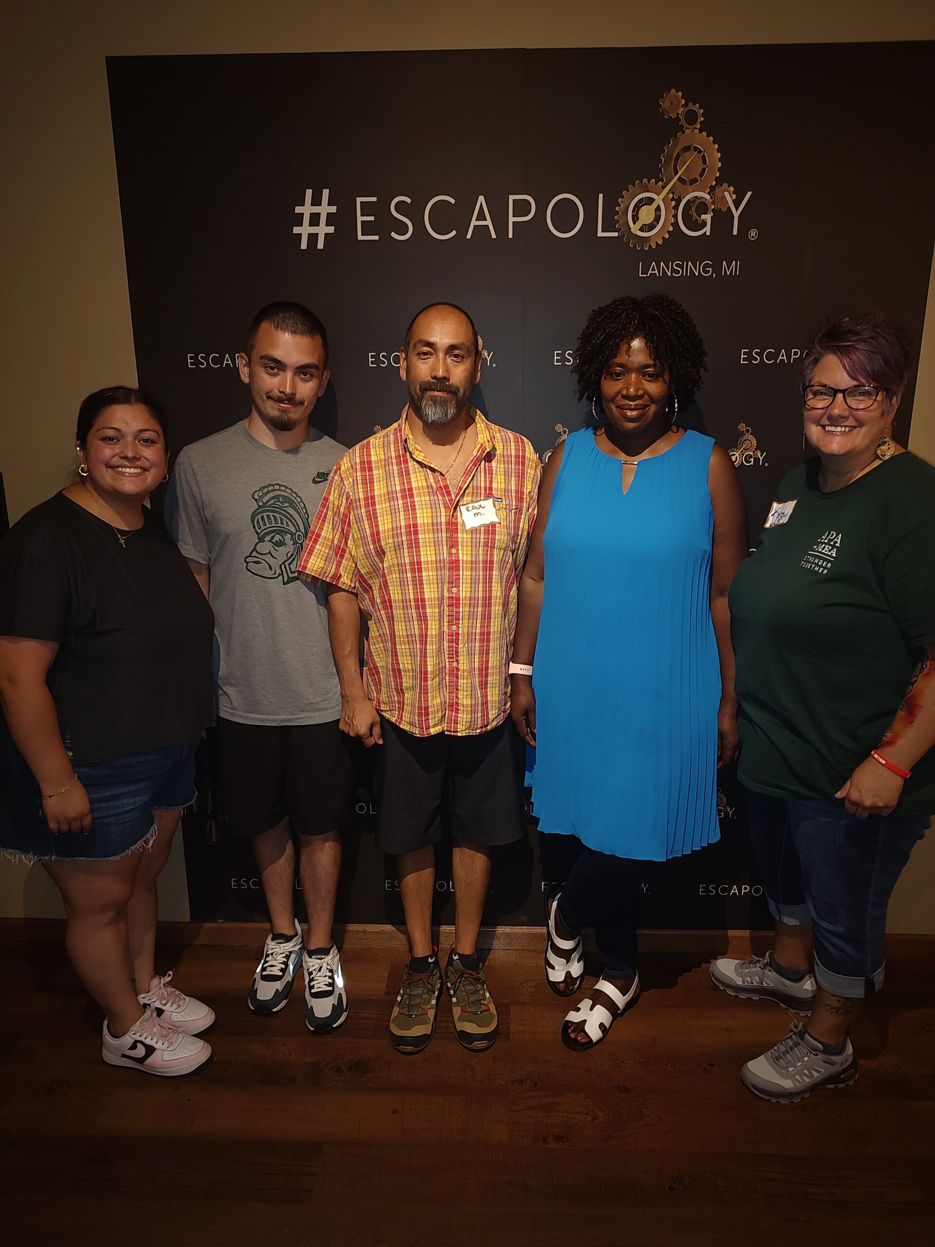 5 APA members in front of Escapology sign